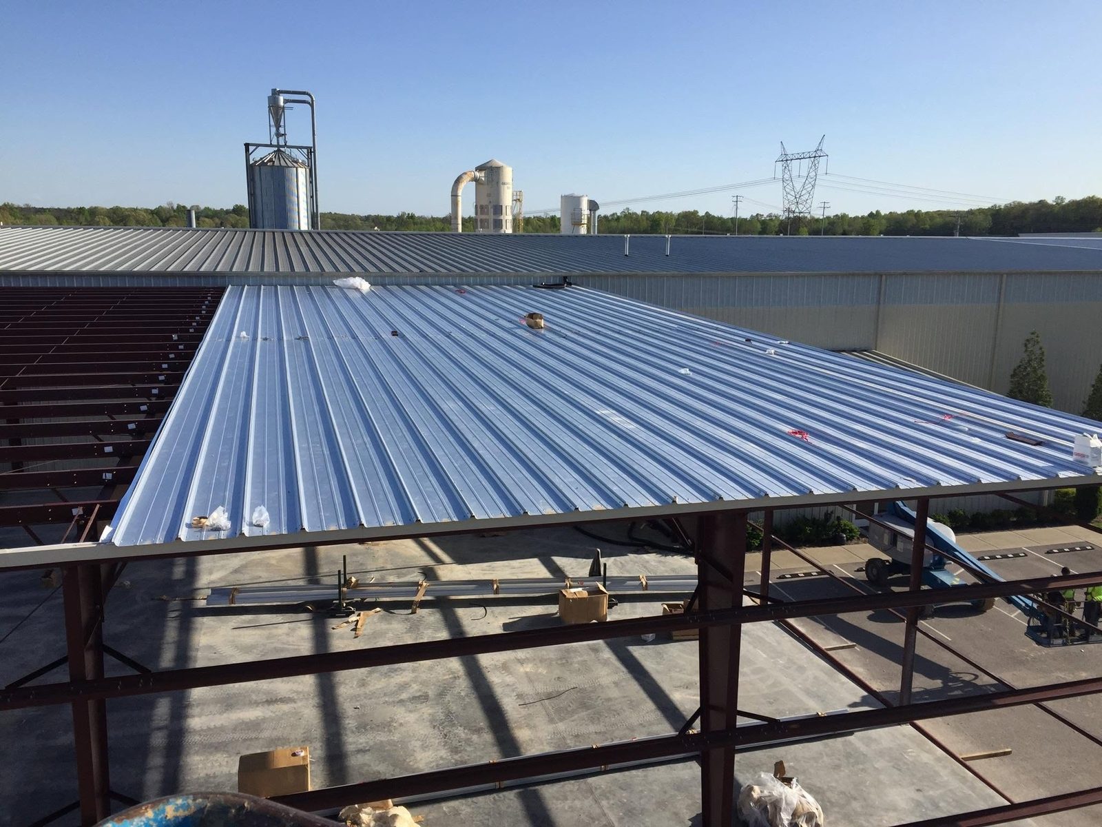 Ground view of multi-building gray metal building complex with overhead doors
