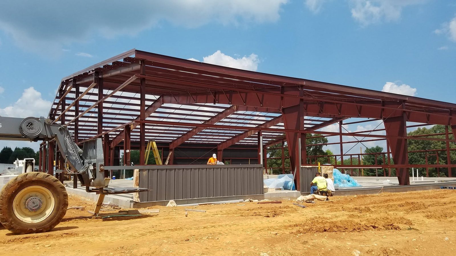 Four-bay cream commercial metal building with lean-to